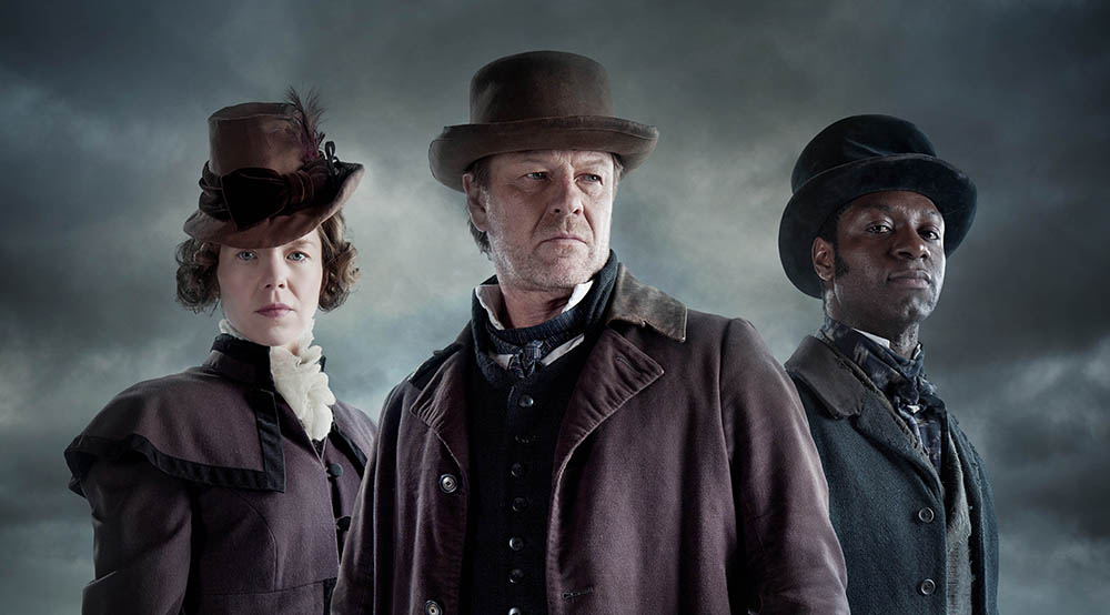 This image is embargoed until 00.01 Tuesday 3rd November 2015 From Rainmark Films The Frankenstein Chronicles on ITV Encore Pictured: Mary Shelley [Anna Maxwell Martin], John Marlott [Sean Bean] and Nightingale [Richie Campbell]. In the drama’s opening sequences, the Home Secretary Sir Robert Peel, following a successful operation by Thames River Police to apprehend a gang of opium smugglers, recruits Marlott. As he stands on the water’s edge contemplating the arrest of the smugglers, Marlott makes a shocking discovery. The body of a dead child is washed up on the shore and on further examination of the corpse he is horrified to discover it’s not actually a child but rather a crude assembly of body parts arranged in a grotesque parody of a human form. The mutilated child-like body leaves an indelible impression on Marlott and he finds himself unable to shake off the memory of what has happened that fateful night. This photograph is (C) ITV Plc and can only be reproduced for editorial purposes directly in connection with the programme or event mentioned above, or ITV plc. Once made available by ITV plc Picture Desk, this photograph can be reproduced once only up until the transmission [TX] date and no reproduction fee will be charged. Any subsequent usage may incur a fee. This photograph must not be manipulated [excluding basic cropping] in a manner which alters the visual appearance of the person photographed deemed detrimental or inappropriate by ITV plc Picture Desk. This photograph must not be syndicated to any other company, publication or website, or permanently archived, without the express written permission of ITV Plc Picture Desk. Full Terms and conditions are available on the website www.itvpictures.com For further information please contact: james.hilder@itv.com / 0207 157 3052